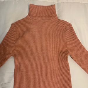Pink form fitting turtleneck